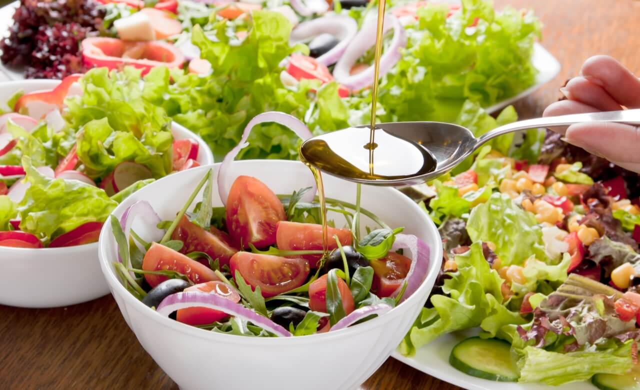 Vini’s fresh garden salads with tomatoes, olives, and red onion, drizzled with olive oil.